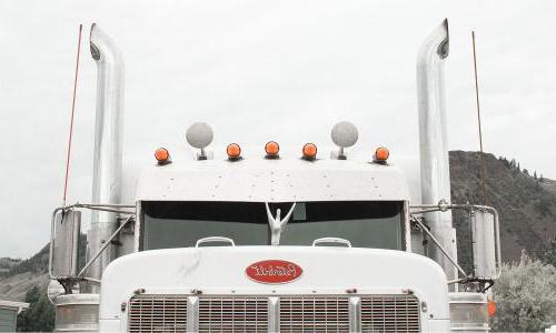 a Peterbilt semi truck with big exhaust pipes